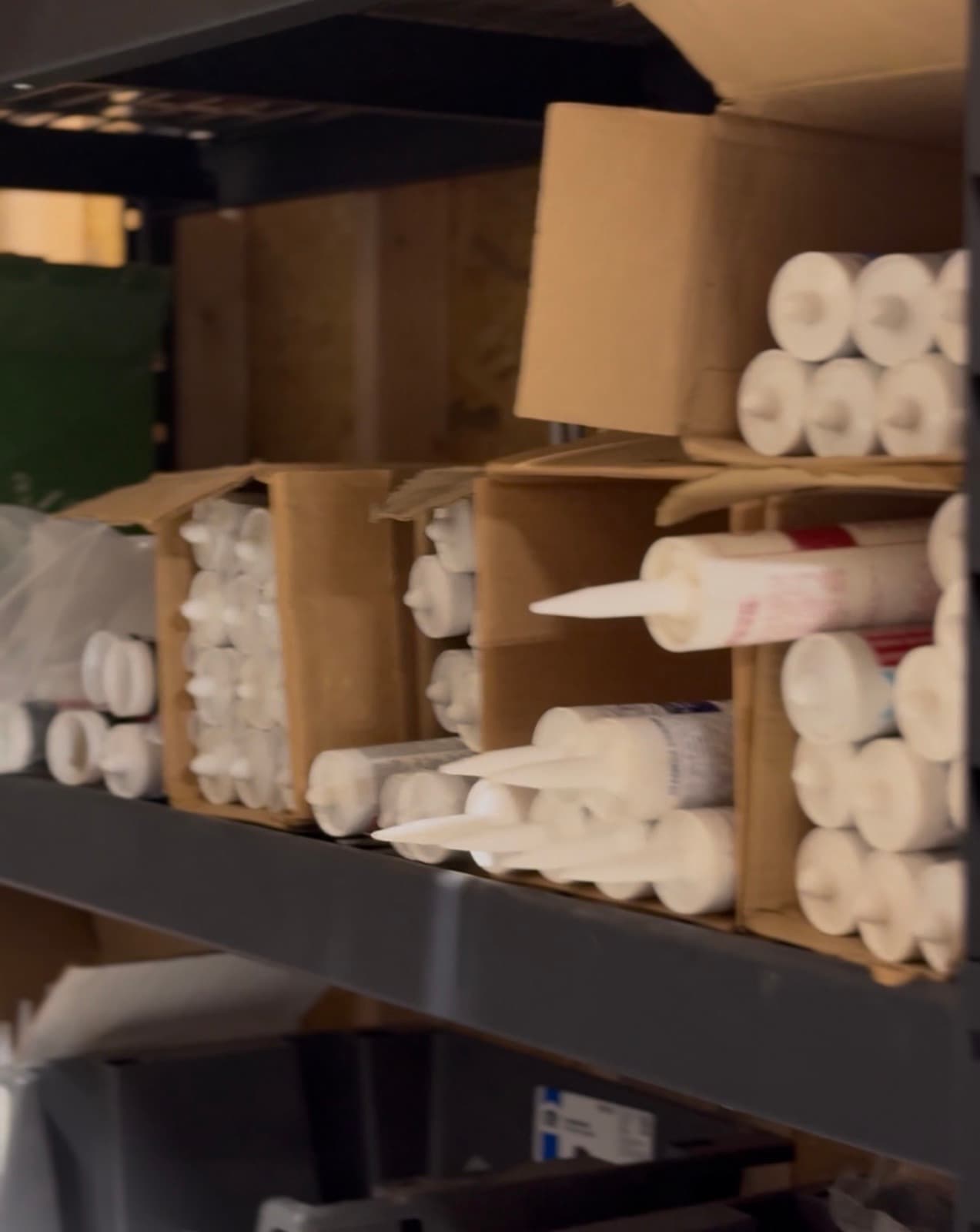Caulk tubes, construction adhesives, and sealants on the shelves at HRI Supply